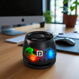 Black cylindrical device with colorful LED lights on a desk