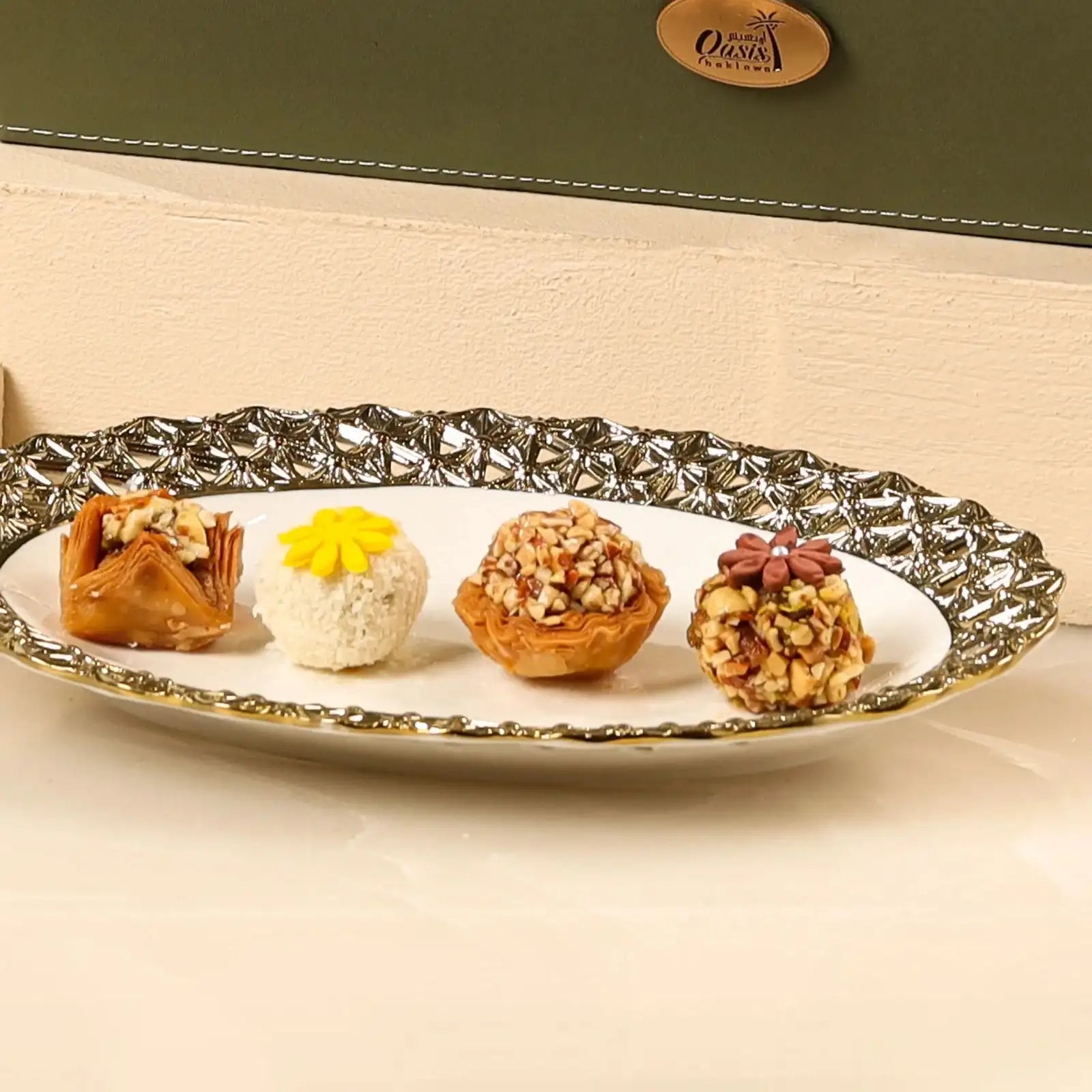 Assorted gourmet sweets including baklava and nut truffles from the Handpicked Flavour Box | Gift Hampers Online, served on a decorative plate.