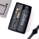 Gift set with water bottle, keychain, pen, and watch on a white background