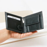 Black leather wallet held in a hand with a white card inside, on a light background
