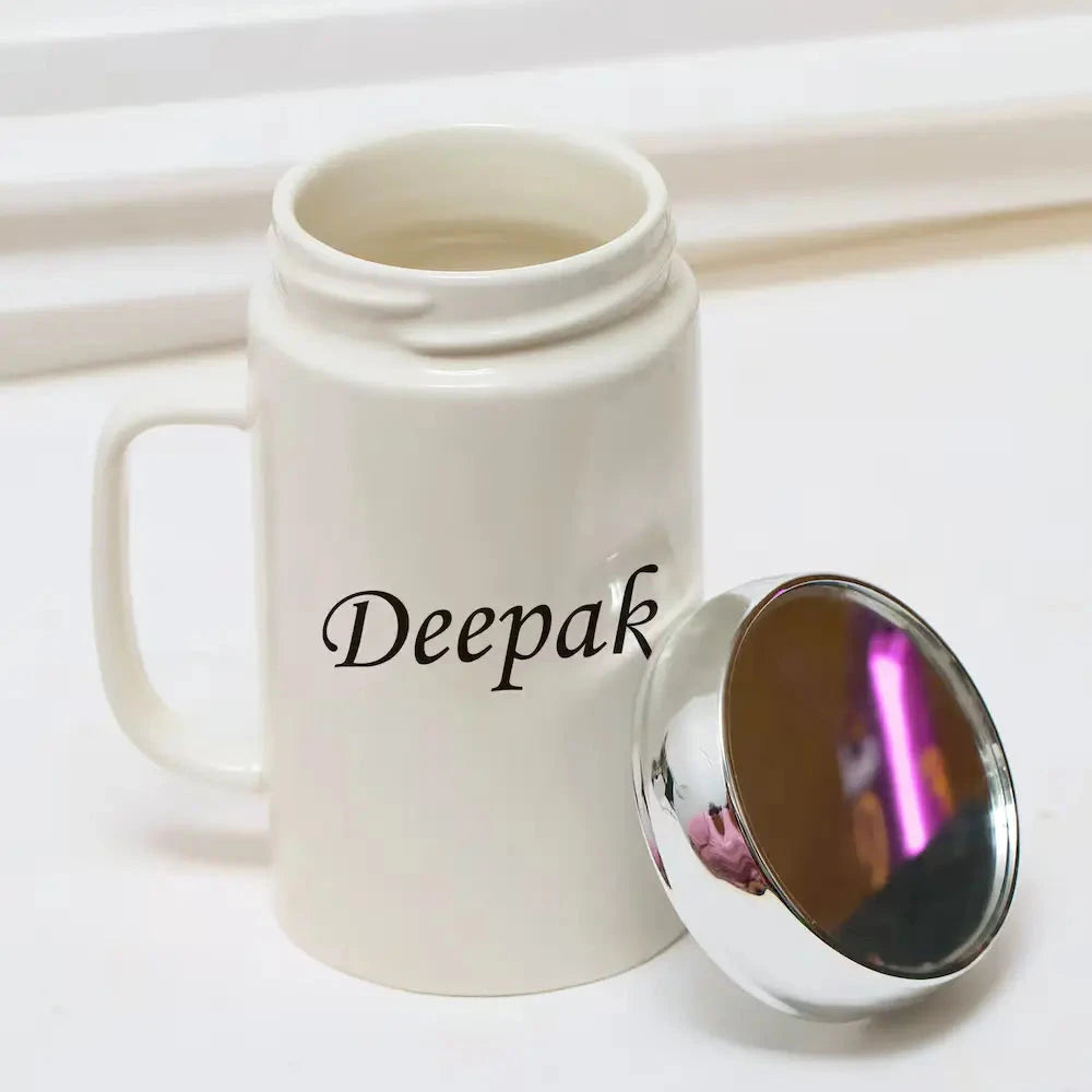 Open personalized ceramic coffee mug with mirror lid placed beside it, showcasing the name 'Deepak' on the front.