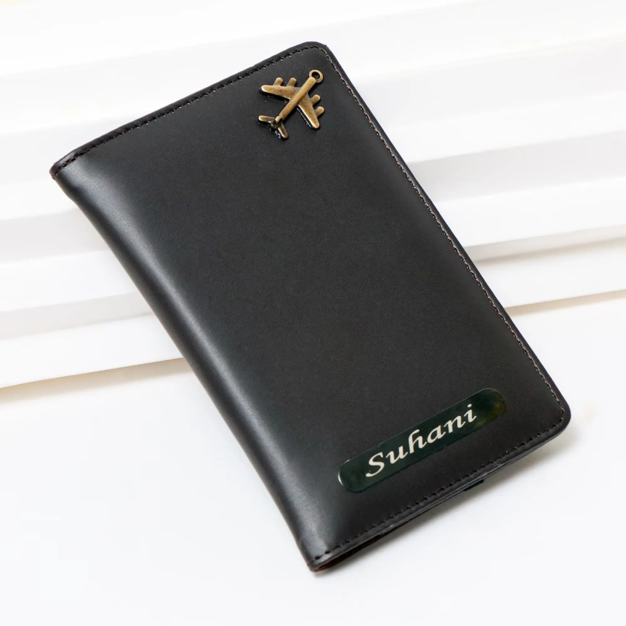 Black leather wallet with gold emblem and 'Suhani' branding on a white background