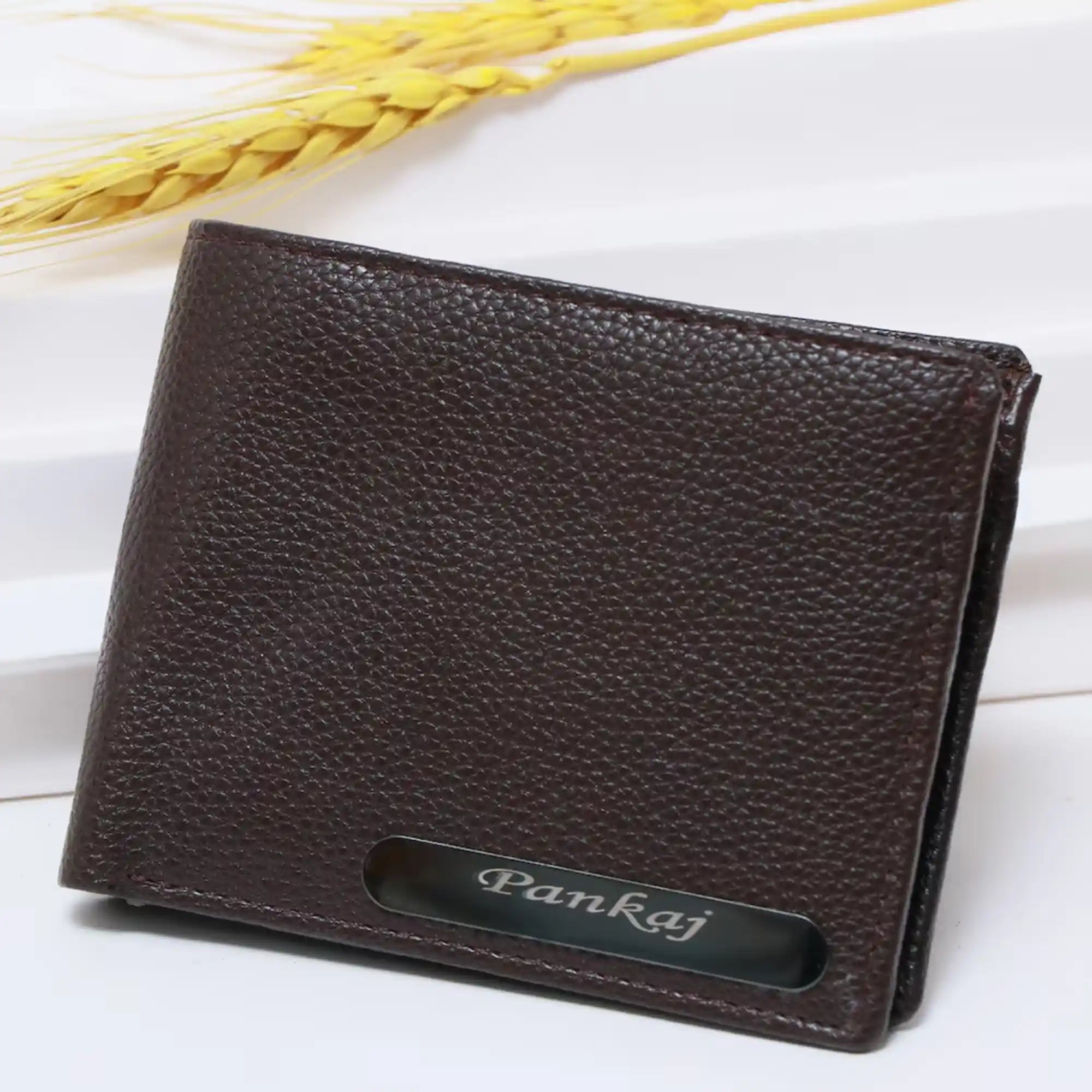 Brown leather wallet with 'Pankaj' branding on a white background