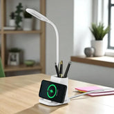 Desk setup with a white LED desk lamp, phone stand, and pen holder on a wooden table.