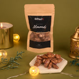 Rose Petal Almonds - Unique Floral Treat | 50g pack of roasted almonds coated with rose petals, displayed with festive lights and decor.