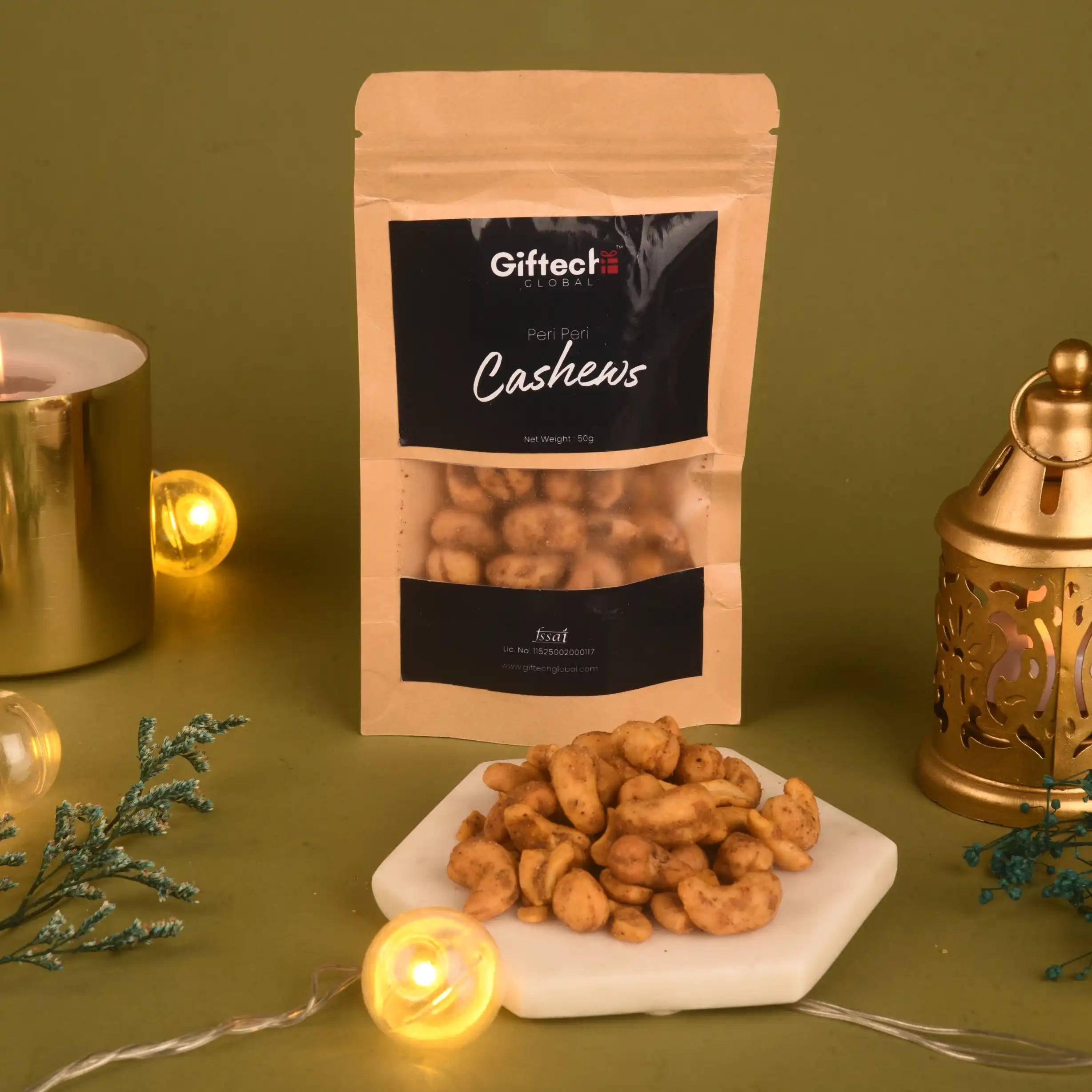 Spicy Cashews - Peri Peri Roasted 50g pack displayed with festive lights and decor, showcasing crunchy snack from Gifted Gourmet.