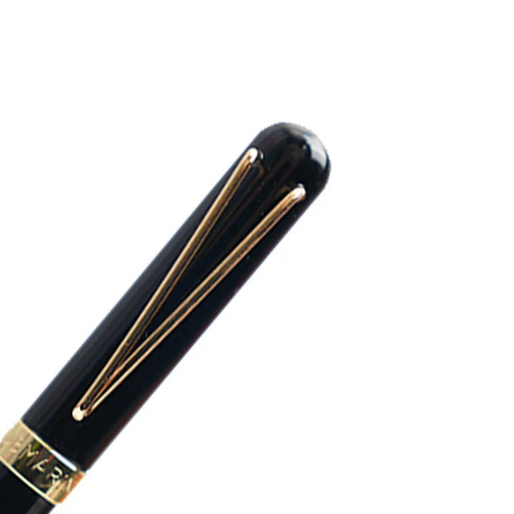 Black pen with gold accents on a white background
