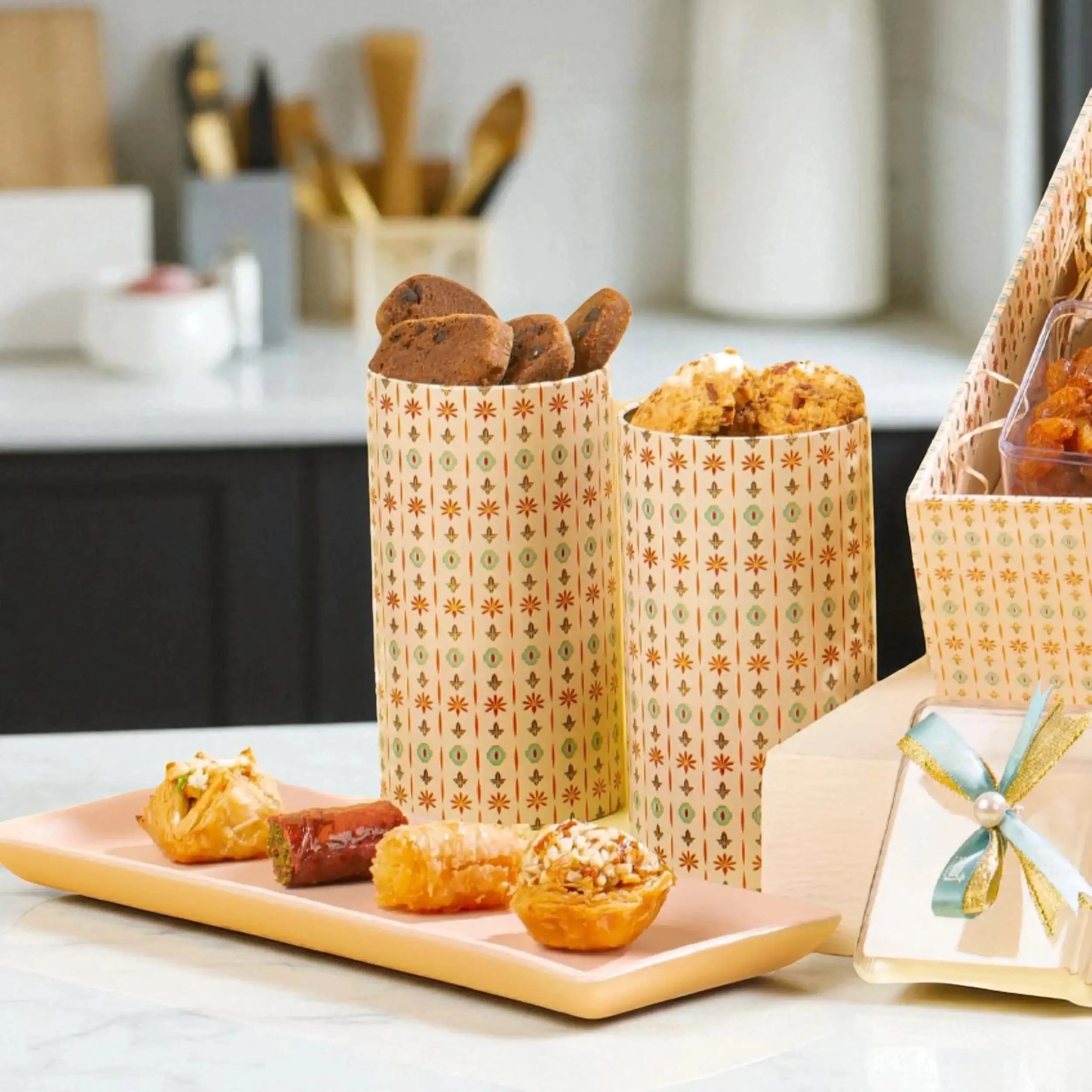 Assorted cookies and sweets in decorative containers from the Grand Delights Gourmet Hamper, ideal for festive and corporate gift hampers.