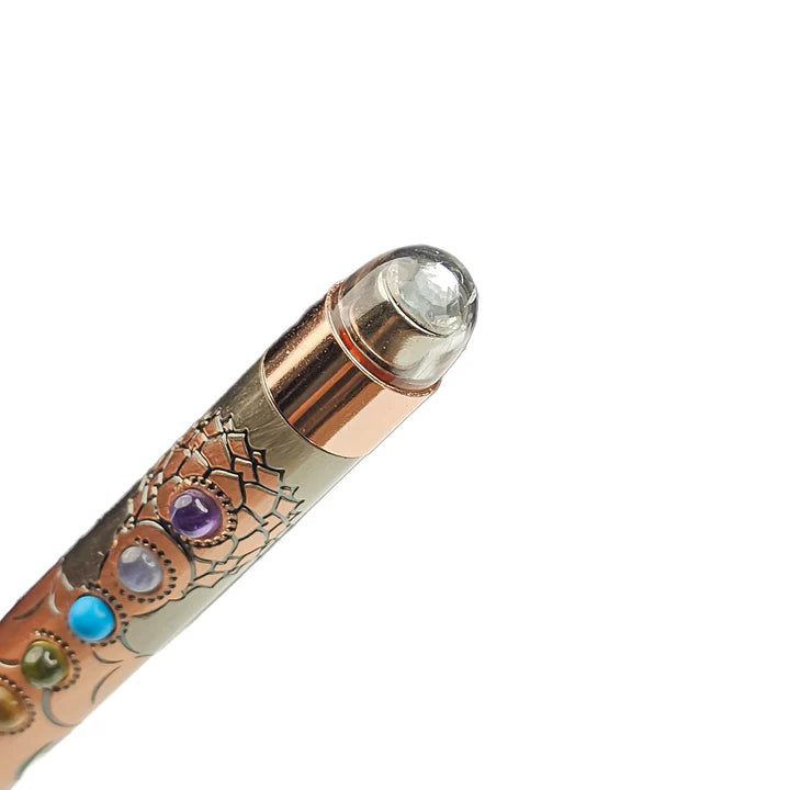 Decorative pen with gemstones on a white background