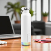 White water bottle with rainbow base on a desk in an office setting