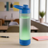 Gradient blue to green water bottle on a desk with a classroom background