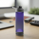 Purple water bottle with black cap on a desk