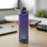 Purple water bottle with black cap on a desk