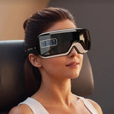 Woman wearing tech eye massager with digital displays, set against a blurred background.