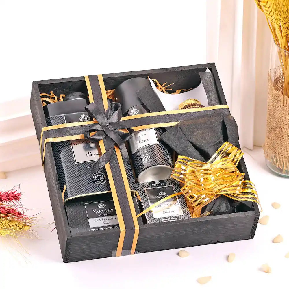 Top view of Yardley Black Kit for Men gift hamper including body spray, soap, talc, shaving cream, and chocolates in a festive box.