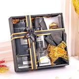 Stylish Yardley Black Kit for Men gift set with grooming products and chocolates in a black wooden box tied with gold ribbon.