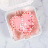 Top view of I Love You Mini Vanilla Cake with pink icing and heart decorations, perfect for gifting on birthdays or special occasions.