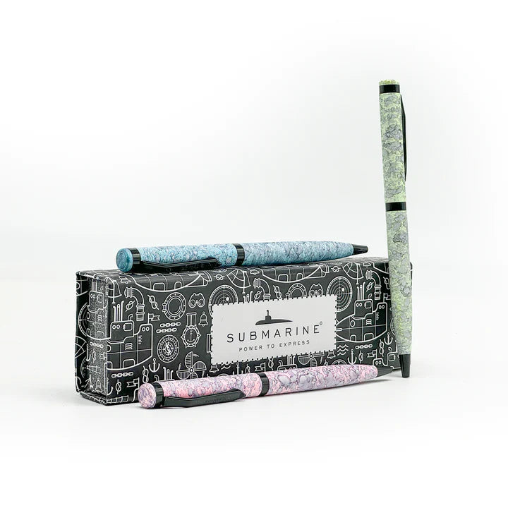 Three pens with decorative designs in a branded box on a white background