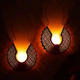 Decorative hanging lights with intricate designs on a dark background