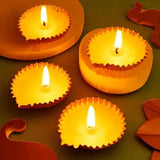 Golden metal diyas glowing brightly, part of Spark Joy Basket - Diwali Gift Mithai & Diyas for festive ambiance.