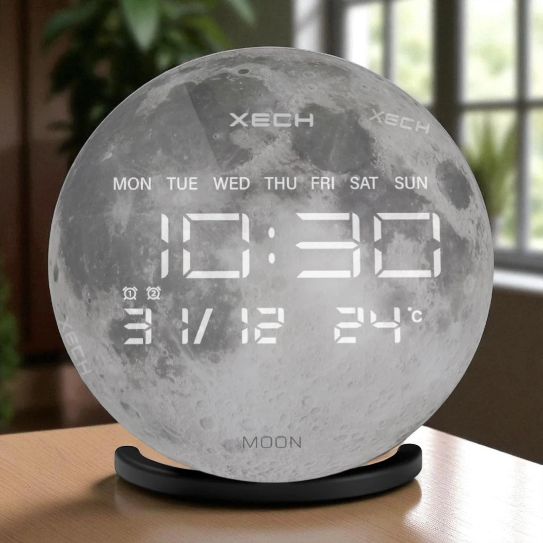 Moon-shaped digital clock with time, date, and temperature display on a wooden surface.