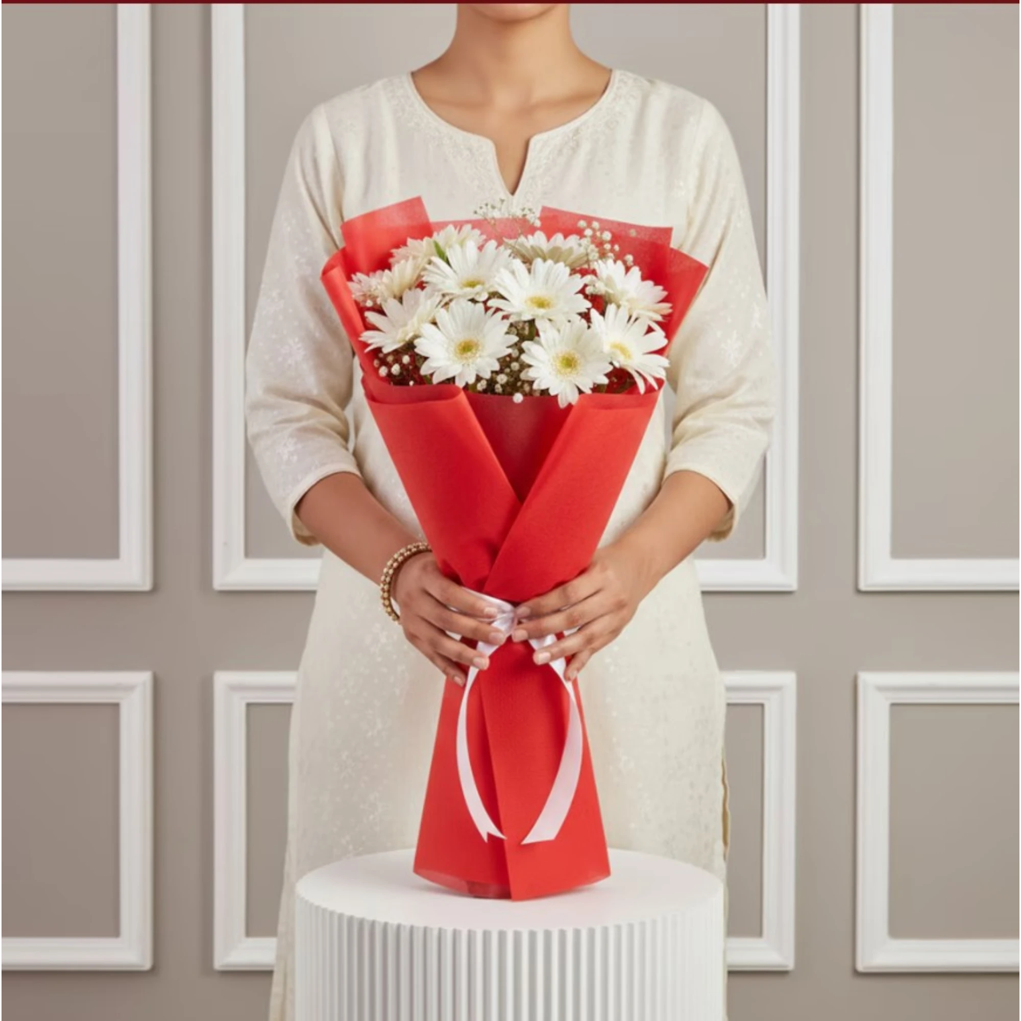 Close-up of white daisies in red wrapping