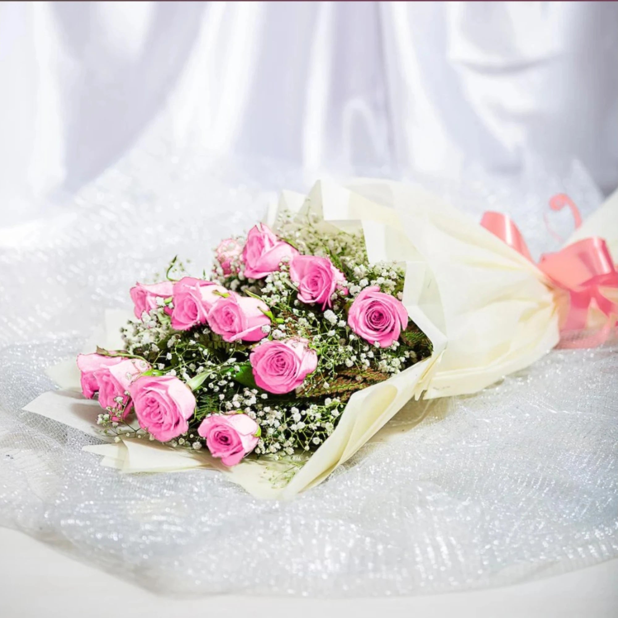 Close-up of pink roses bouquet with baby's breath