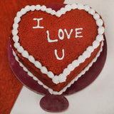 Delicious red velvet heart shape cake with white cream border and cherry filling, perfect for gifting on special occasions.