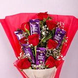 Roses and Chocolate Gift Arrangement with red roses and Cadbury Dairy Milk bars in pink wrapping. Ideal for Valentine's Day gifts online.