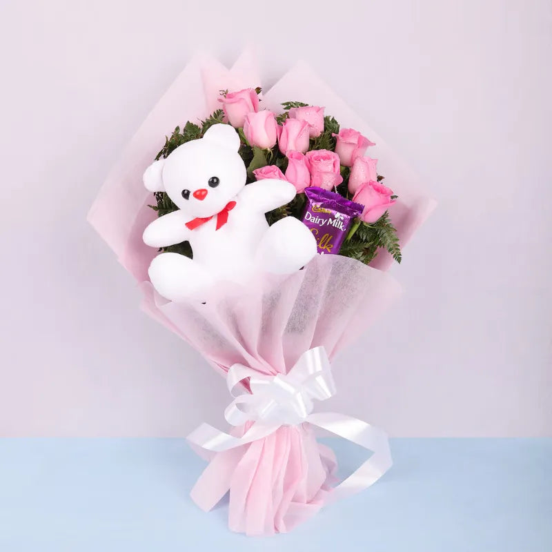 Pink Roses Display with Teddy and Chocolate, ideal for Valentine's Day or proposals, includes fresh pink roses, Dairy Milk, and plush teddy bear.