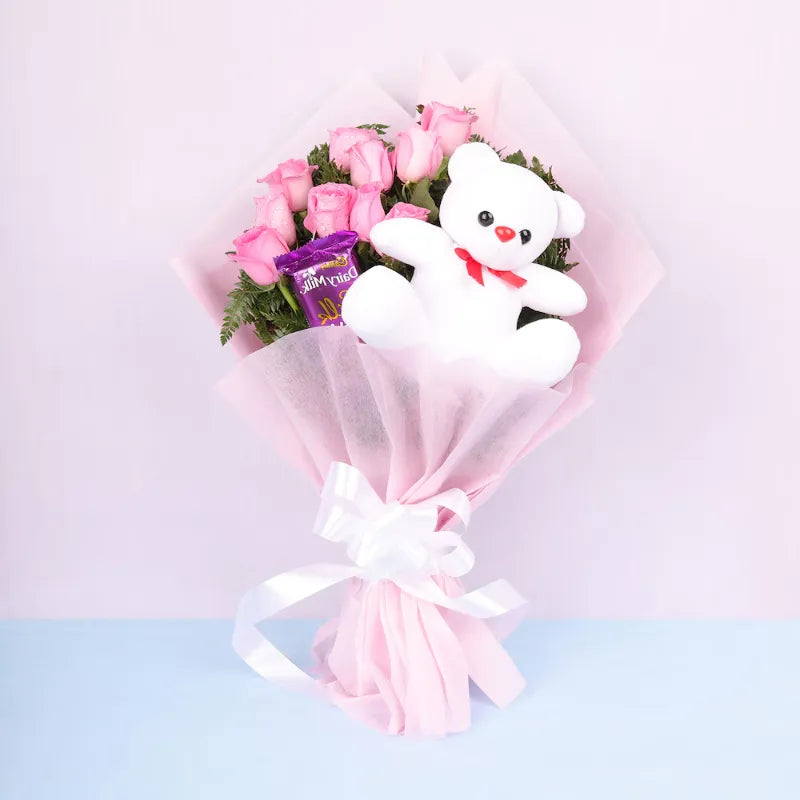 Wonderful Pink Roses Display with Cake and Teddy Bear featuring pink roses bouquet, Dairy Milk chocolate, and white teddy bear wrapped in pink paper.