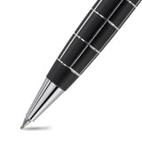 Close-up of a black pen with silver accents on a white background