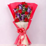 Valentine's Day Roses and Chocolate Gift Arrangement featuring red roses and Dairy Milk chocolates in a pink bouquet wrap with ribbon.