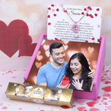 Custom pink pendant gift set with Ferrero Rocher chocolates, personalized card, and romantic couple photo for Valentine's Day gifting.