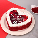 Heart-shaped Red Velvet Valentines Poster Cake with red crumbs and printed 'Happy Valentine's Day' topper, ideal for romantic celebrations.