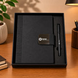 Black notebook and pen set on a wooden surface