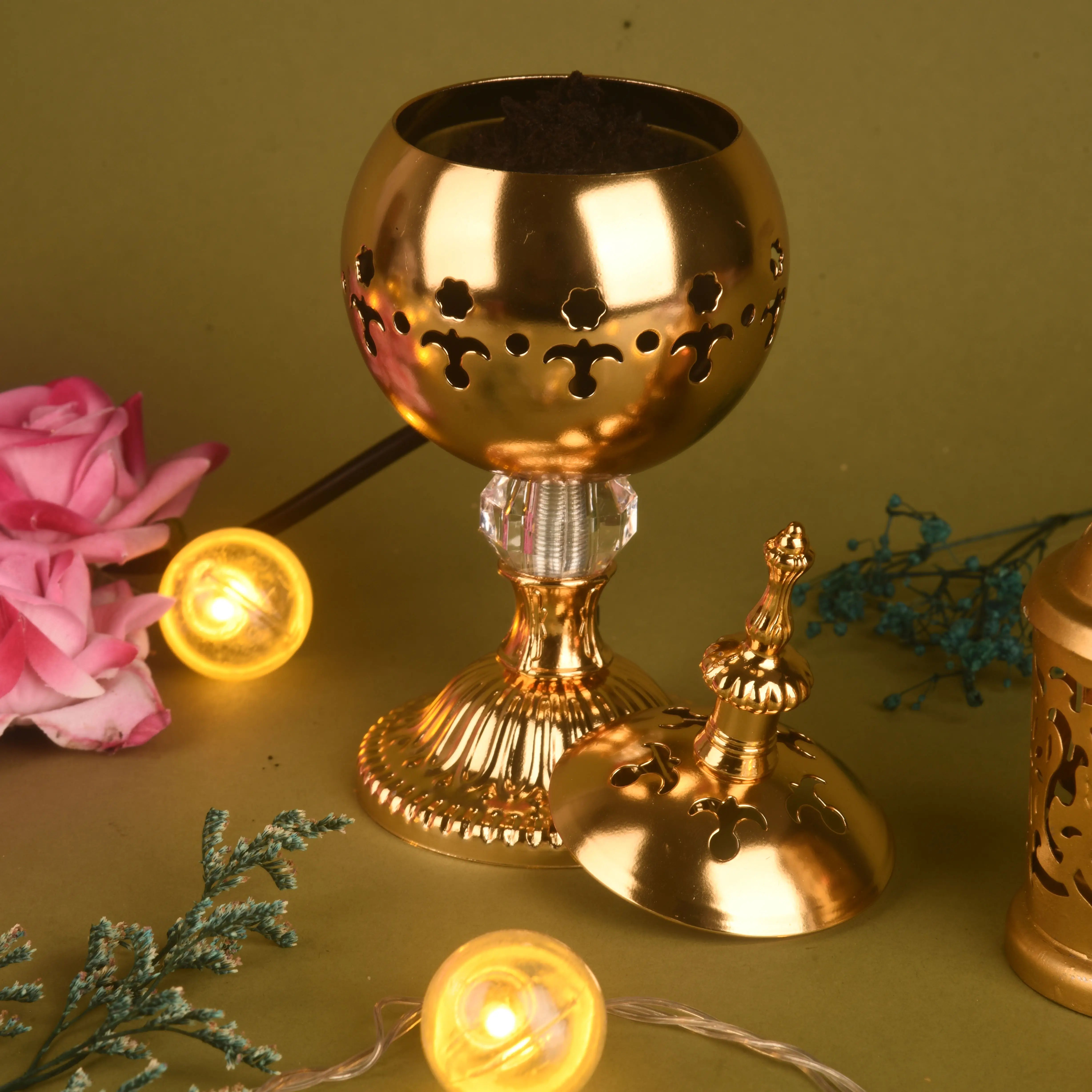 Gold decorative item with cut-out patterns on a green background