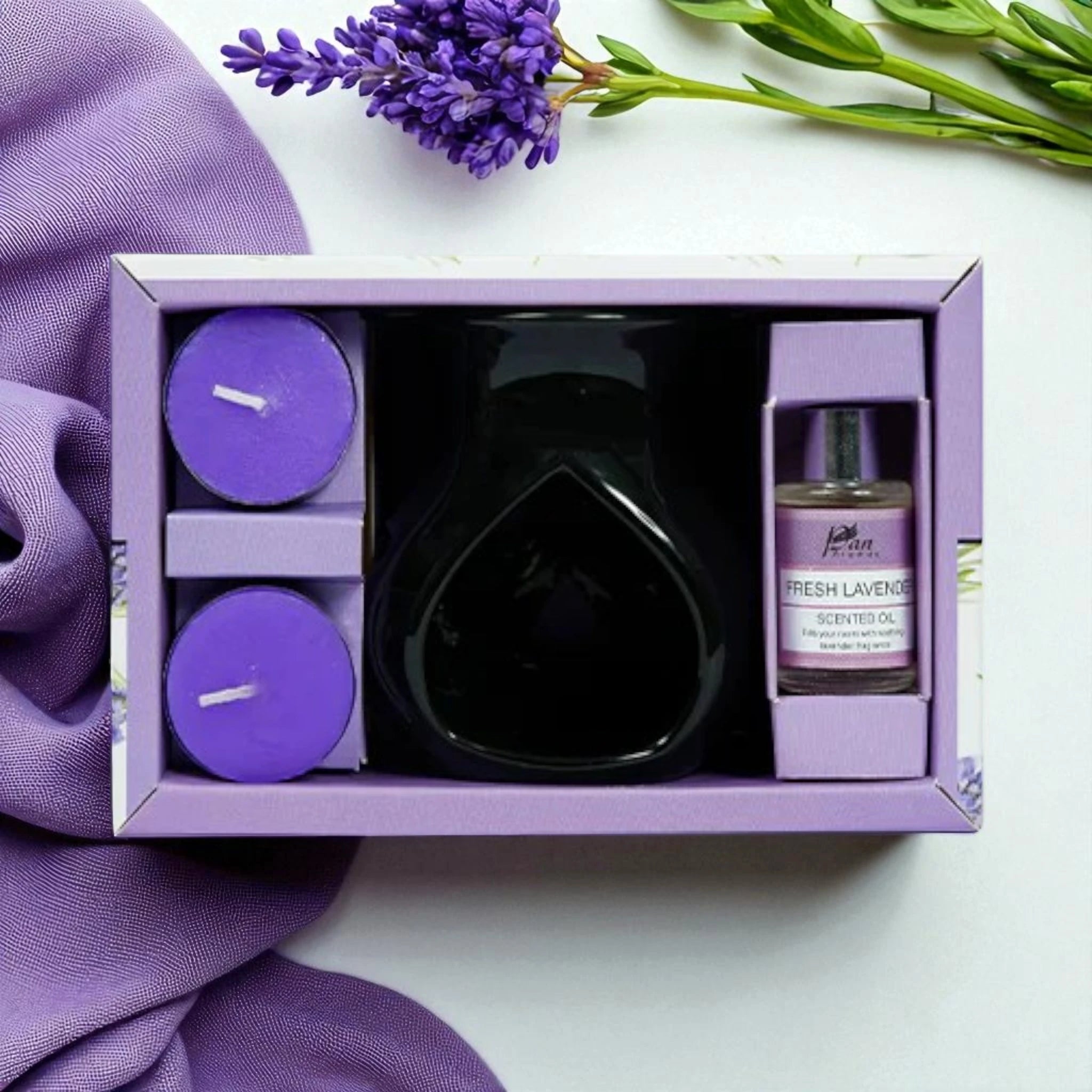 Gift set with lavender-themed items including candles and a diffuser on a white background.