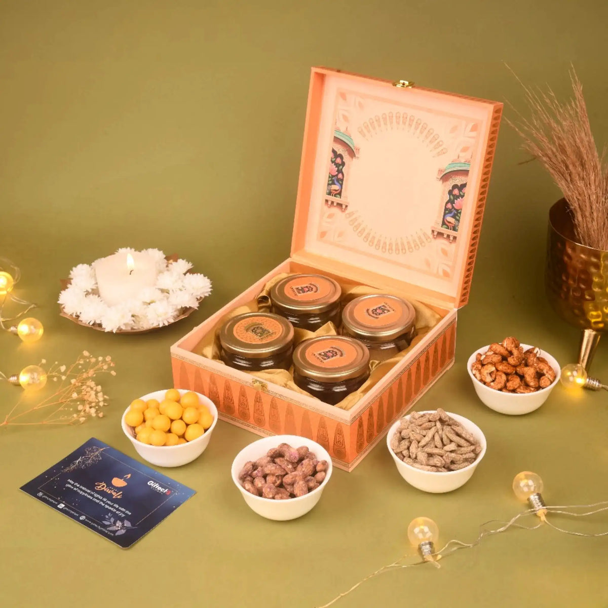 Open Celestial Radiance Hamper displaying gourmet jars of nuts and dragees in a luxurious Diwali gift box, perfect for corporate or festive celebrations.