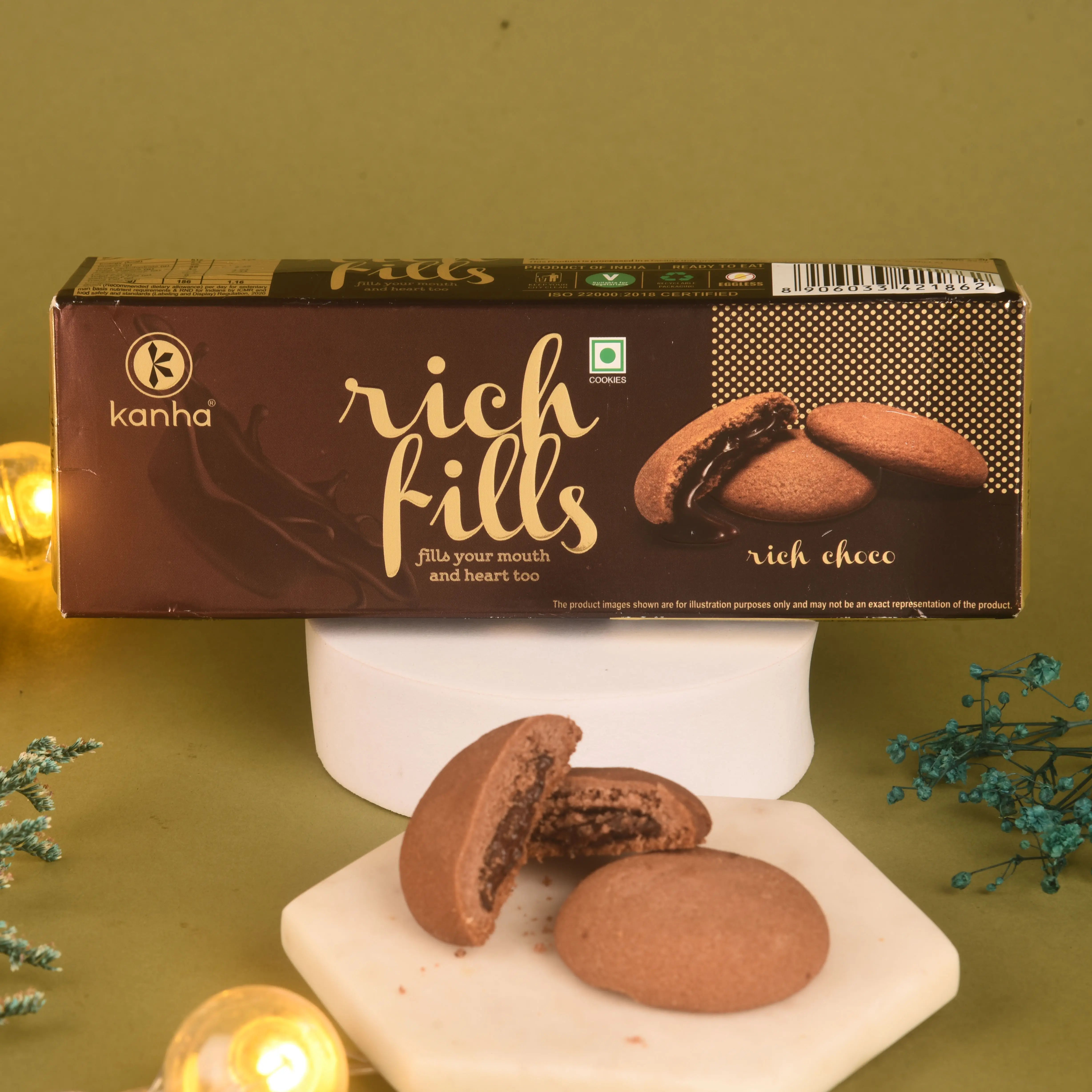 Box of 'Rich Fills' cookies with cookies on a marble slab against a green background
