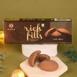 Box of 'Kanha Rich Fills' cookies on a decorative stand with cookies displayed in front.