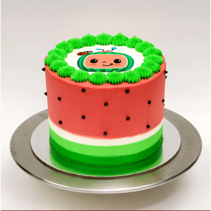 Watermelon-themed birthday cake with green frosting border and cute cartoon watermelon face