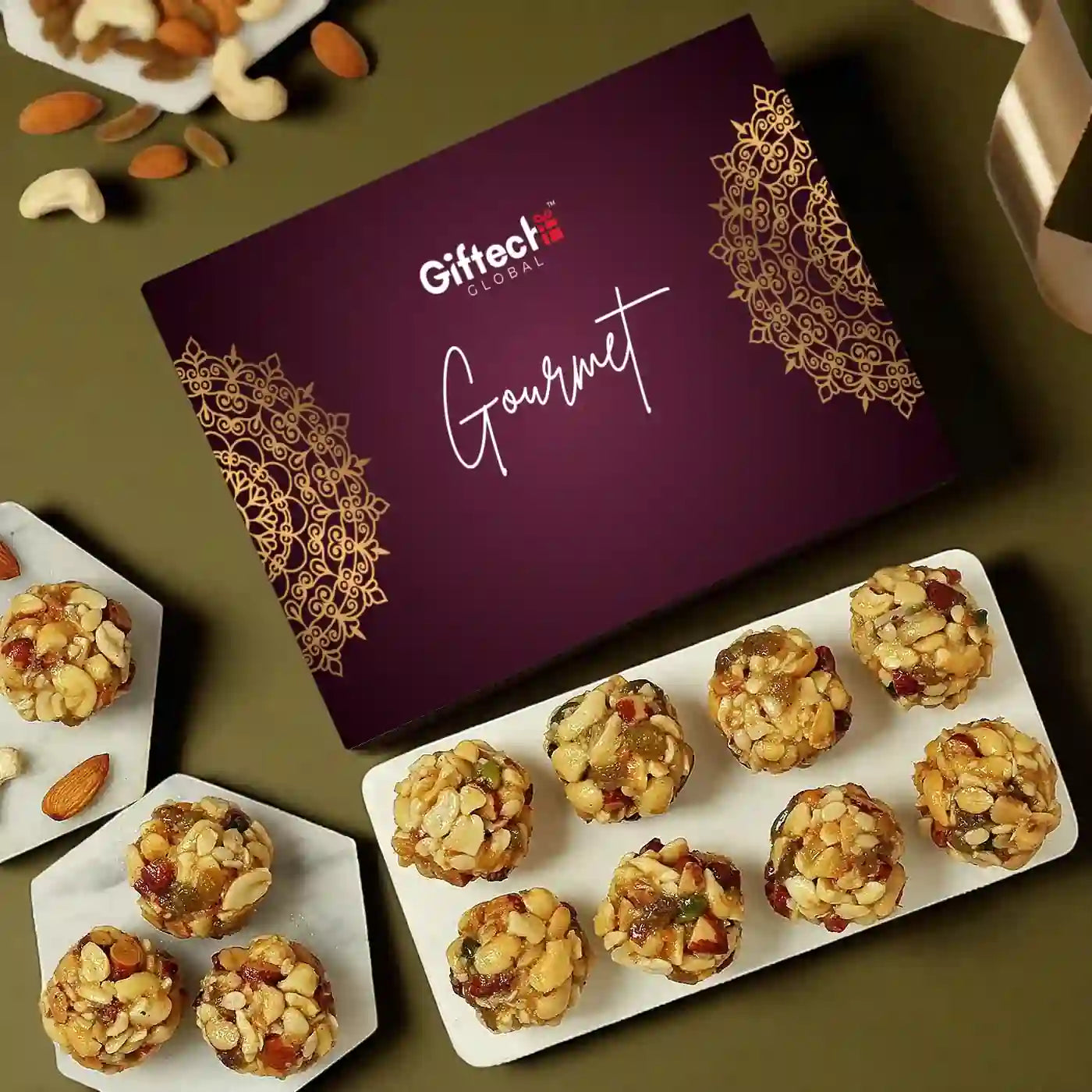 Gourmet snack box with assorted treats on a green background