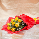 Close-up of yellow roses bouquet with red wrapping