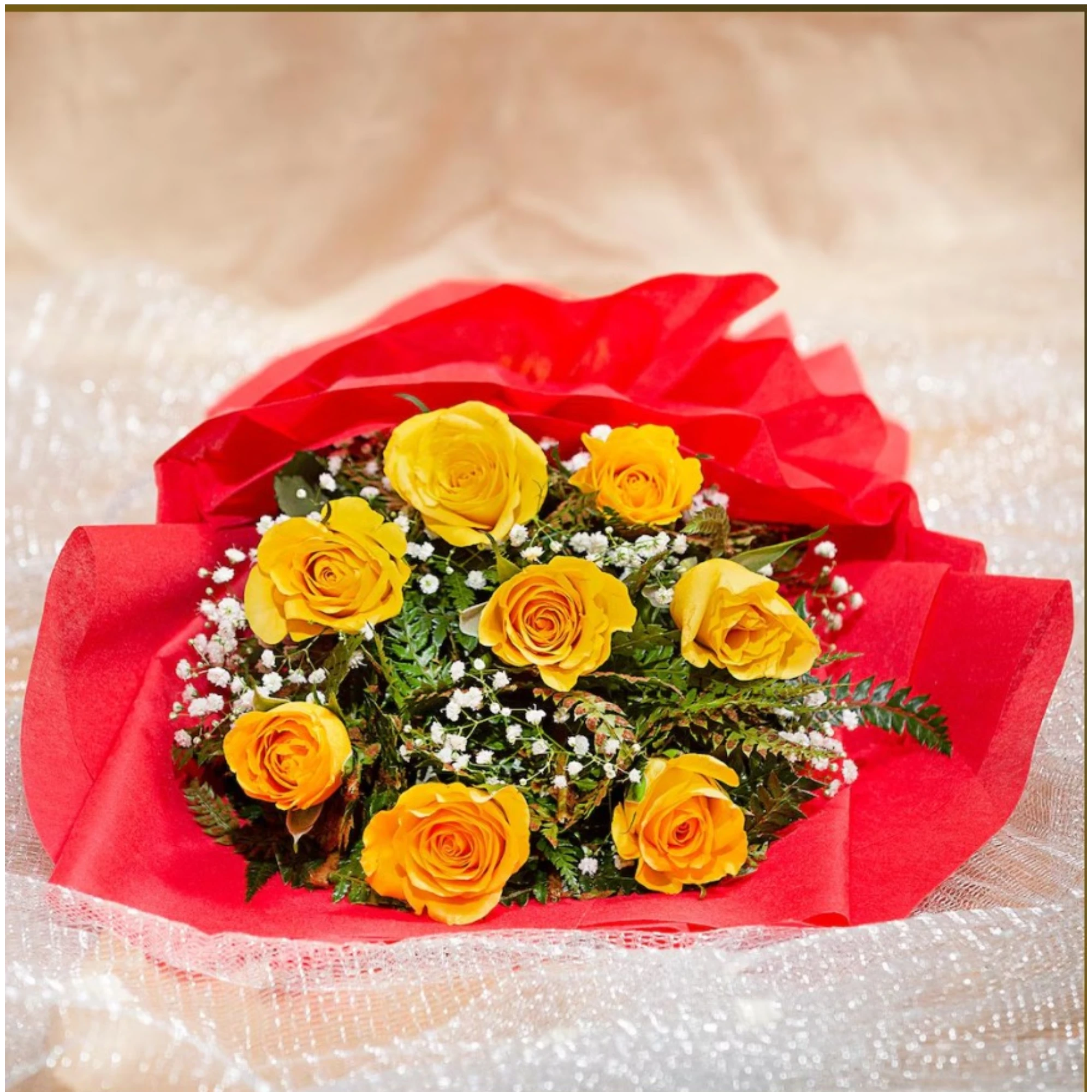 Yellow roses bouquet with red wrapping and white flowers