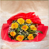 Yellow roses bouquet with red wrapping and white flowers