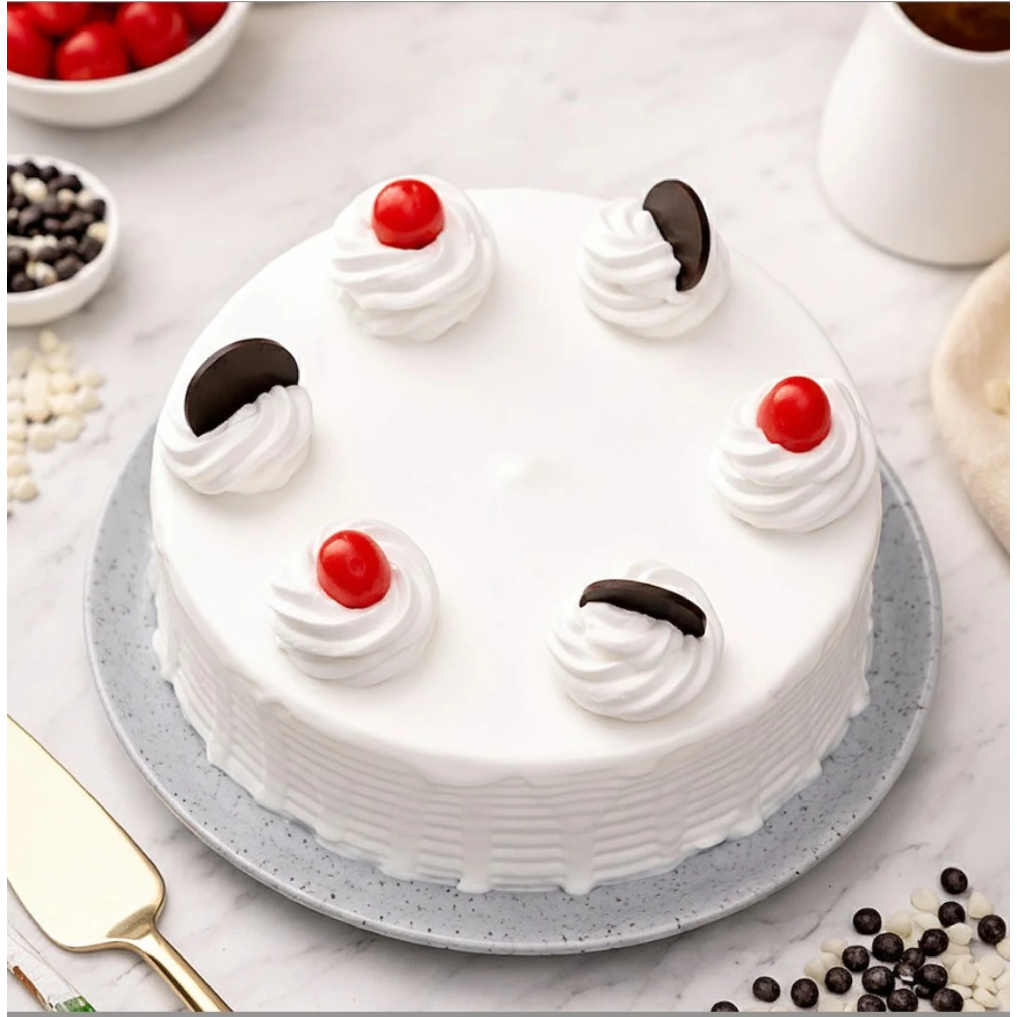 Close-up of decorated cake with cherries and chocolate pieces