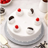 Close-up of decorated cake with cherries and chocolate pieces