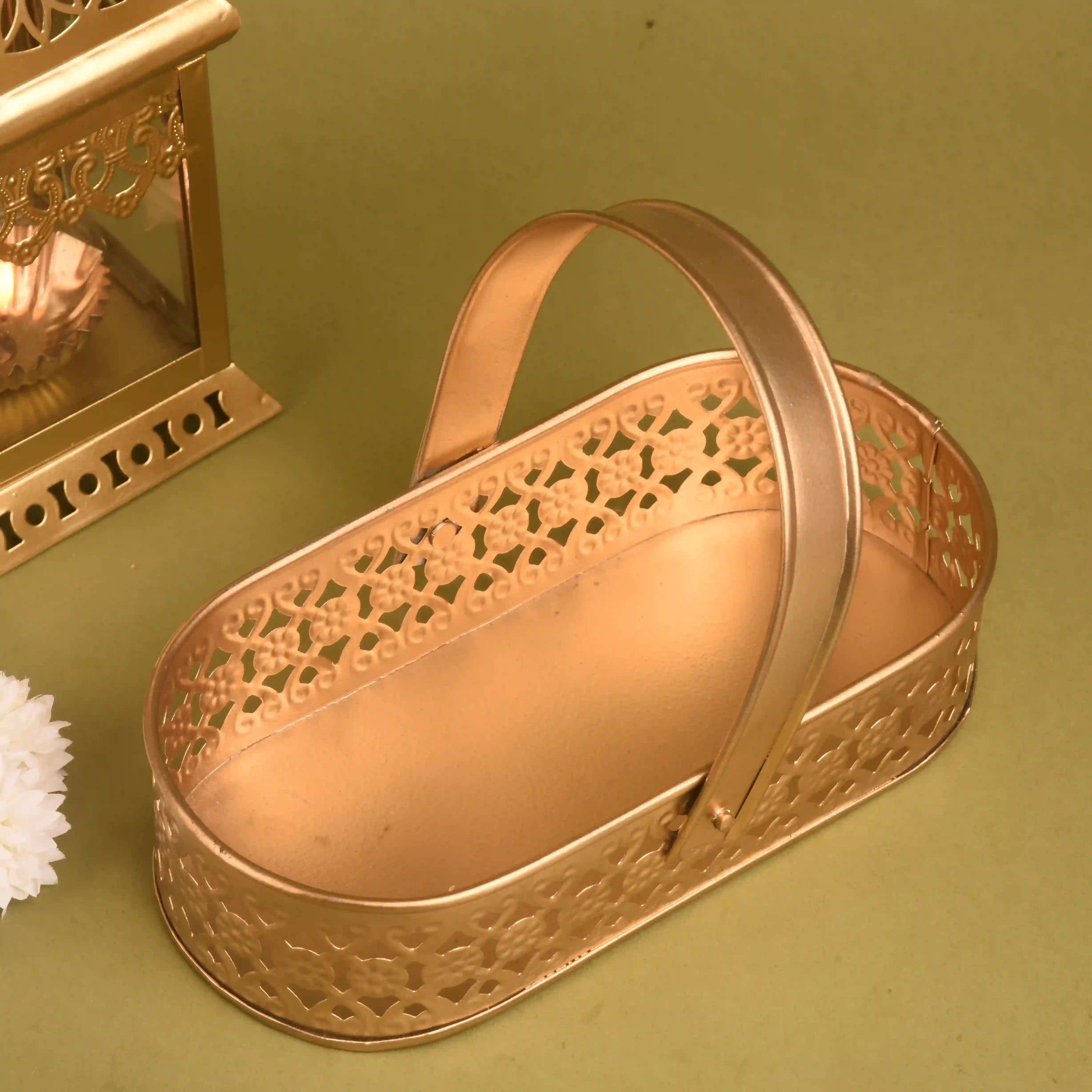 Decorative gold heart-shaped box with intricate designs on a green background