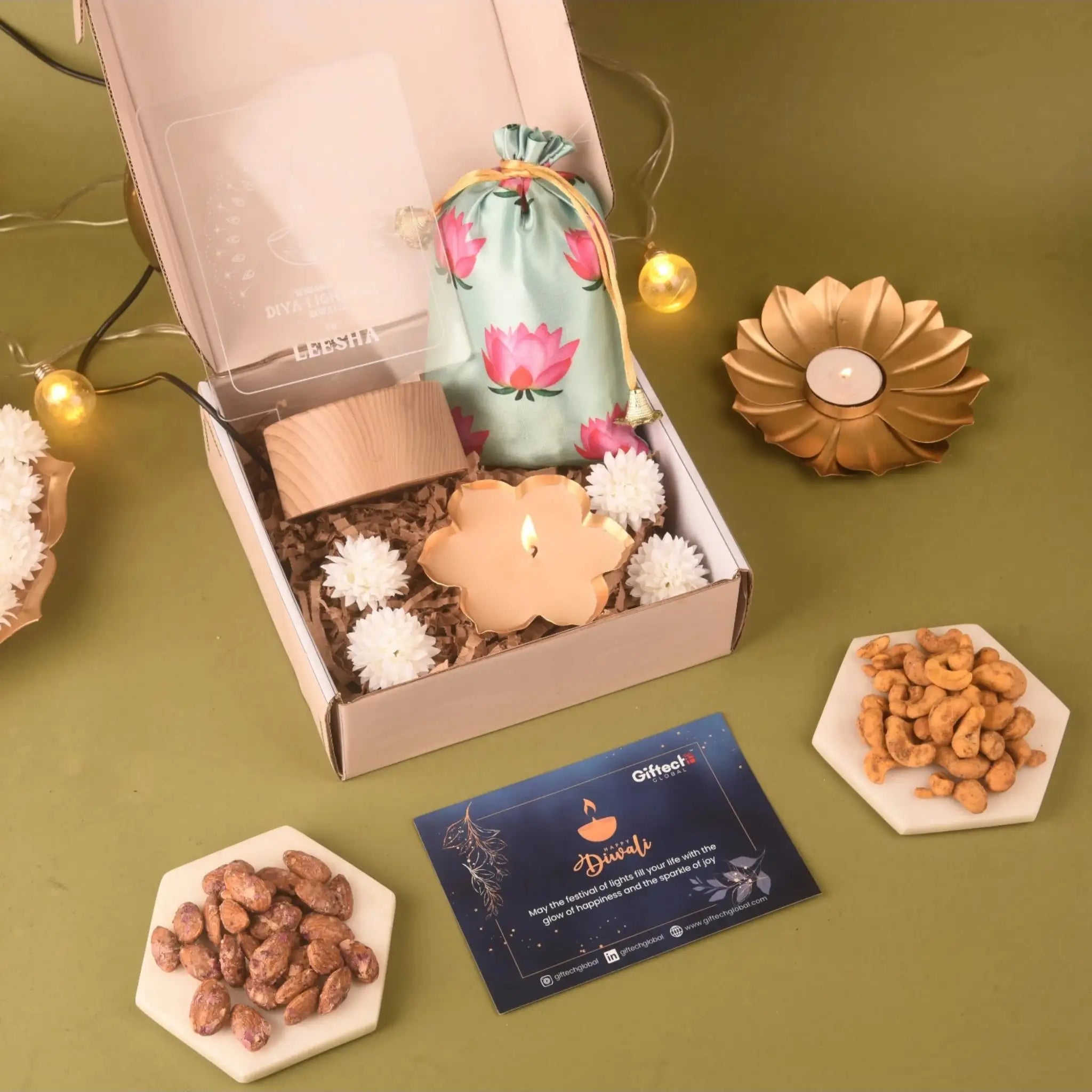 Nutty Indulgence Hamper for Diwali Gifting featuring dry fruits, chocolates, rose aroma diffuser, and decorative diya in festive packaging.